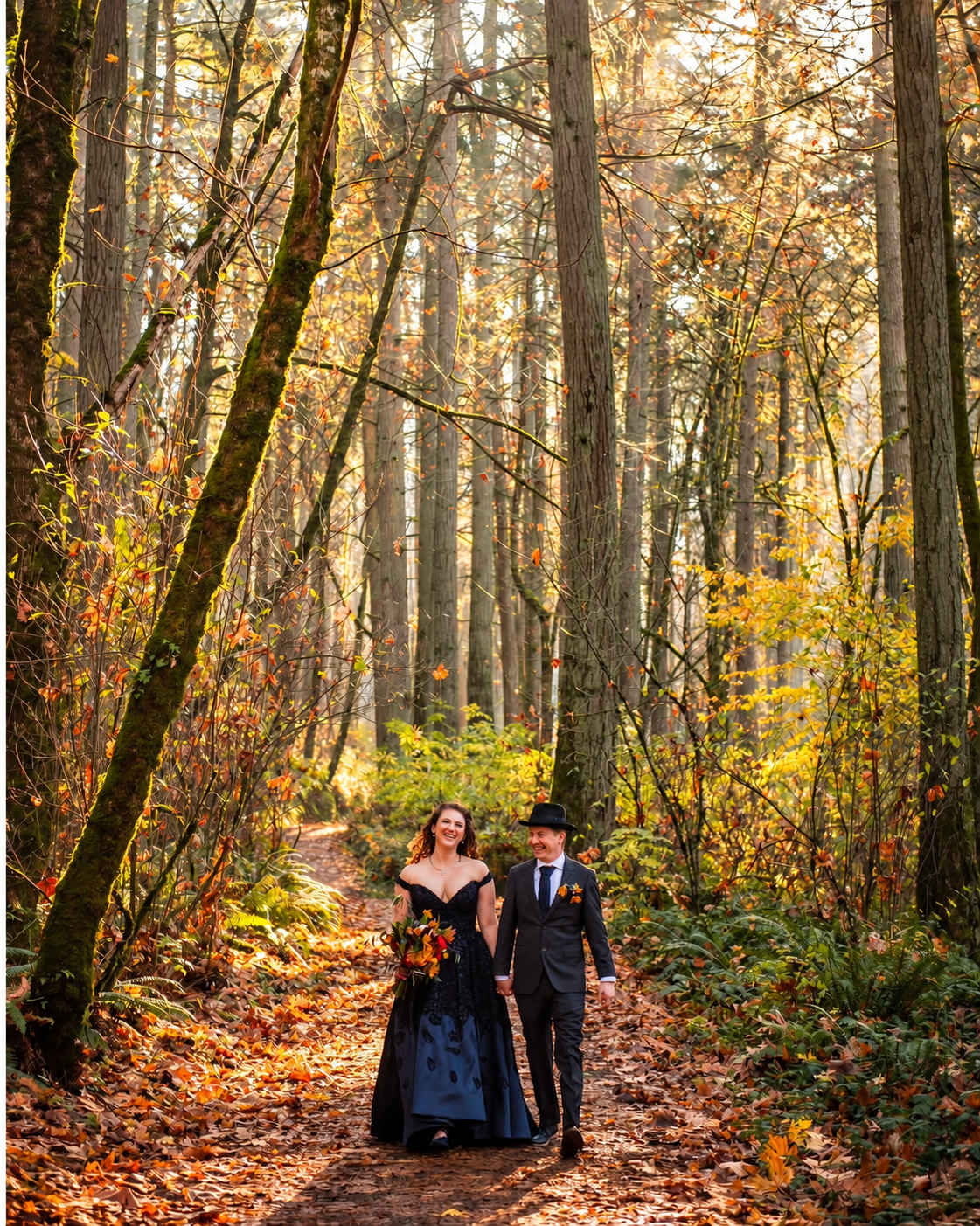 A couple holding hands in a sunlit autumn forest